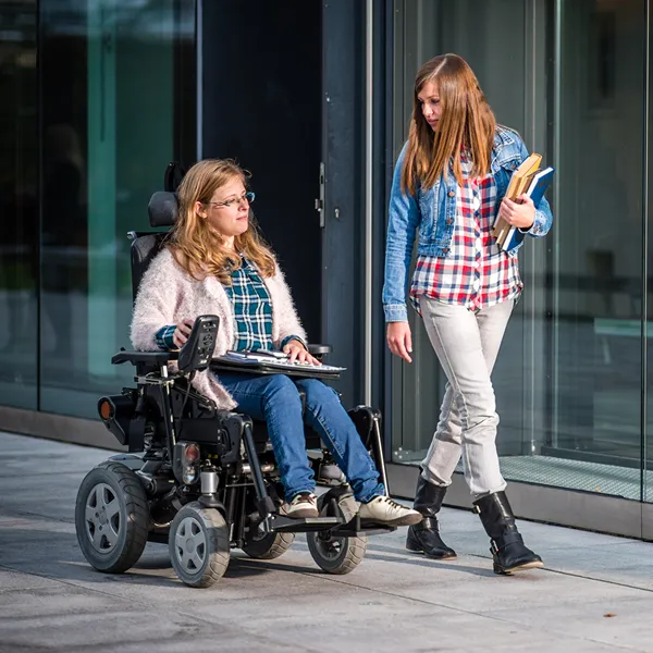 young woman in wheelchair with carer
